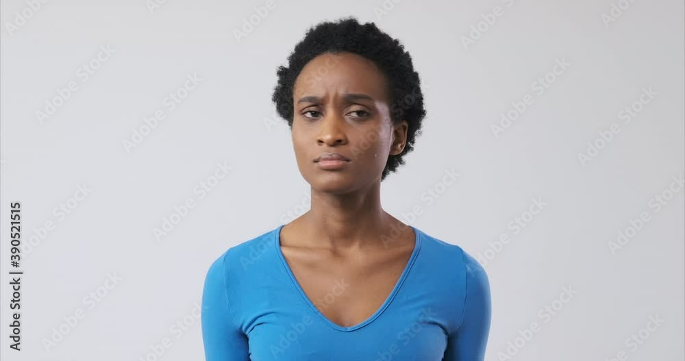 Impatient african american woman checking time on wristwatch Impatient african american woman checking time on wristwatch