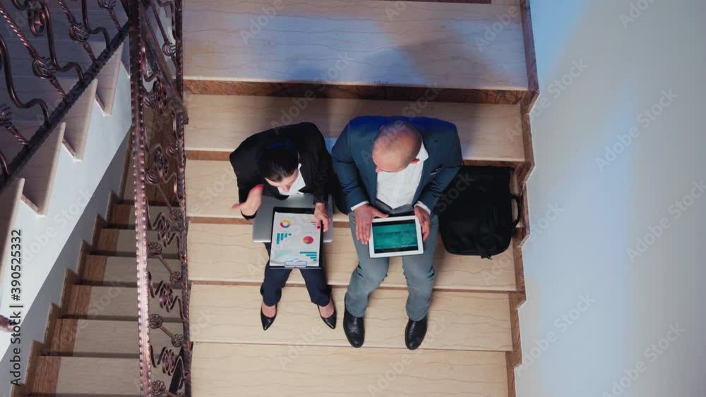 Top view of stressed lady manager screaming at coworker reading raport after hours about deadline financial crisis sitting on stairs in corporate building. Businesswoman overworking explaining project Top view of stressed lady manager screaming at coworker reading raport after hours about deadline financial crisis sitting on stairs in corporate building. Businesswoman overworking explaining project