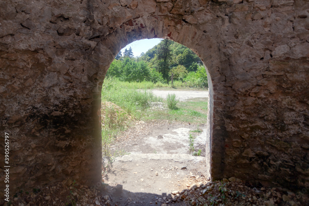 Arched exit from the old fortress of white stone