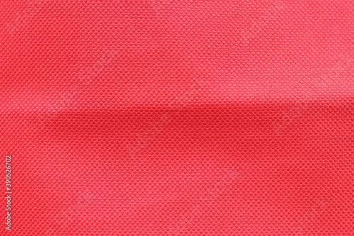 Red fabric texture background for Christmas and New Year festival. Surface of red textured cloth as backdrop and wallpaper.