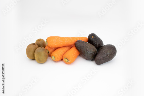 Avocado kiwi carrot on white background.