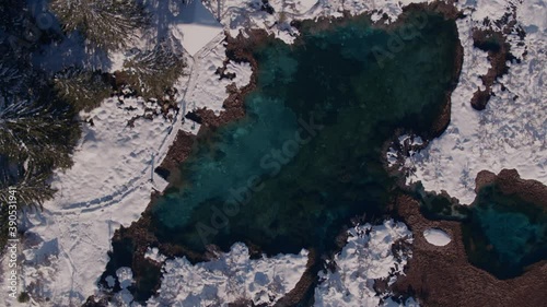 Top down drone video of nature reserve Zelenci.
Bright green colour of a lake with idyllic winter scene - Zelenci in Slovenia. photo