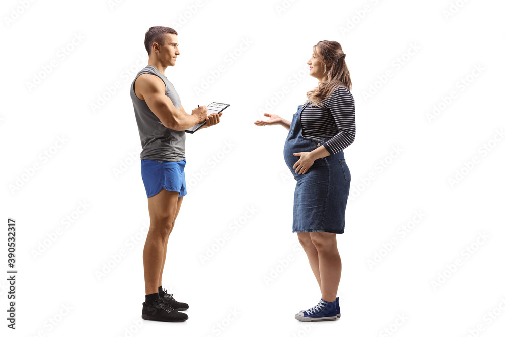 Fototapeta premium Full length profile shot of a pregnant woman talking to a fitness instructor
