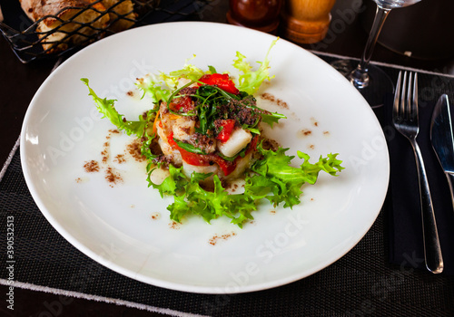 Codfish timbale with fried red peppers, arugula and olive oil