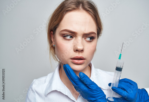 Woman syringe anesthesia botox injection doctor blue gloves