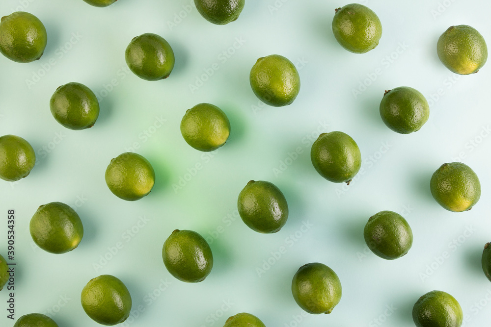 Pattern of natural green lemons on a light green background
Pattern of natural green lemons on a light green background
