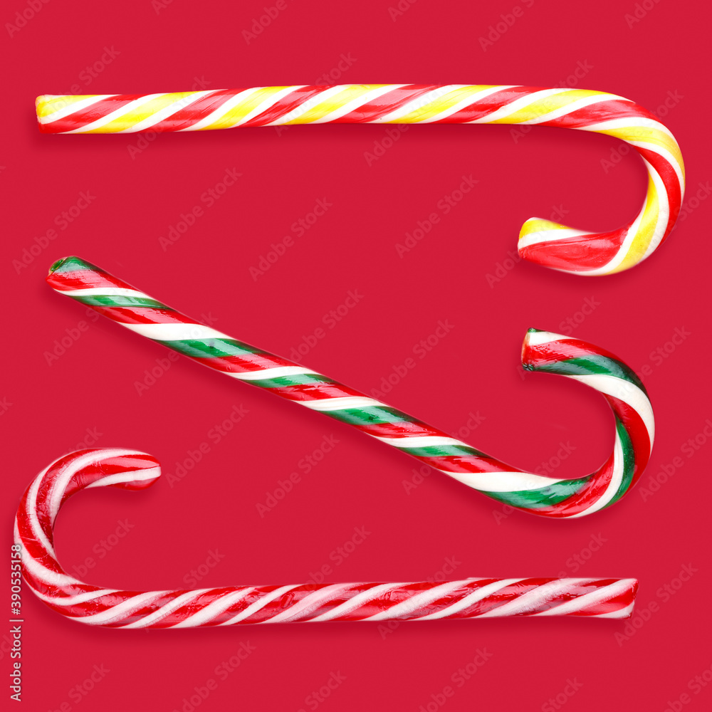 Fototapeta premium candy canes lollipops christmas on a red background