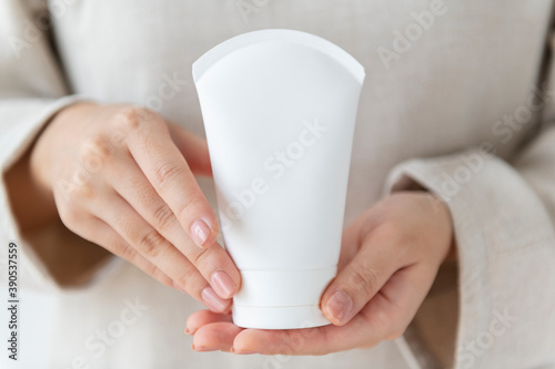 Woman holding a facial cream tube