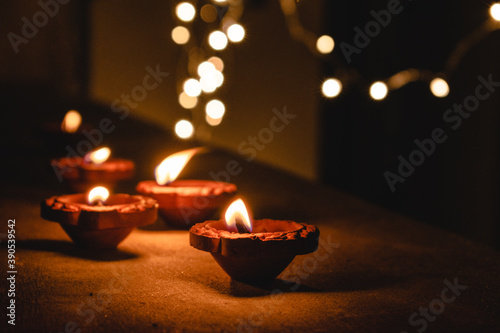 Photography Diwali Diya oil lamp lit during diwali festival in India with bokeh lights isolated in black background