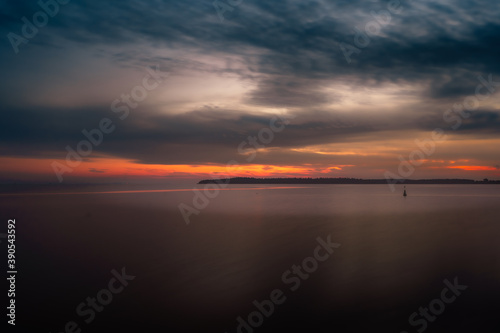 cloudy sunset over the river © KARUPPASAMY
