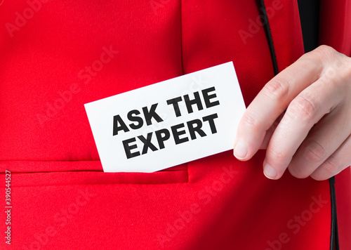 Businessman putting a card with text Ask the Expert in the pocket, business concept.