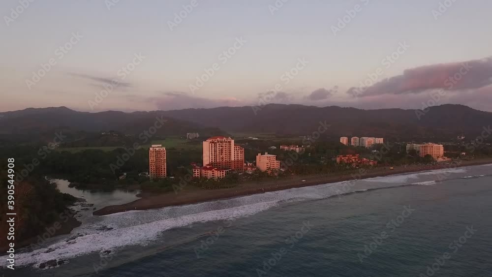 This video shows a picturesque Jaco beach in Costa Rica during a gorgeous sunset. The Palms Jaco condominium complex and Croc's Resort and Casino can be seen directly behind the beach. This video shows a picturesque Jaco beach in Costa Rica during a gorgeous sunset. The Palms Jaco condominium complex and Croc's Resort and Casino can be seen directly behind the beach.