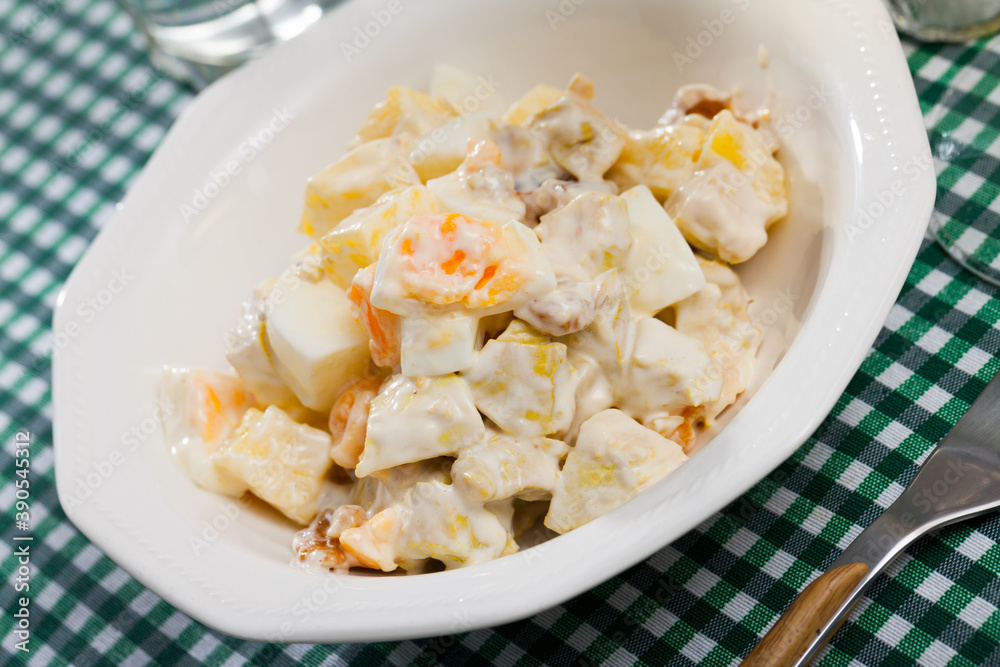 Delicious salad with chicken fillet, pineapple and eggs, dressed with yogurt sauce