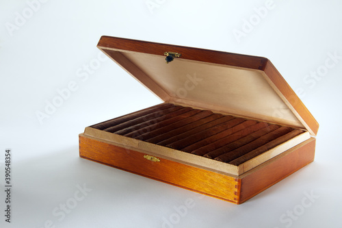 Tableau sur toile View of nice wooden humidor with cigars in it on white back