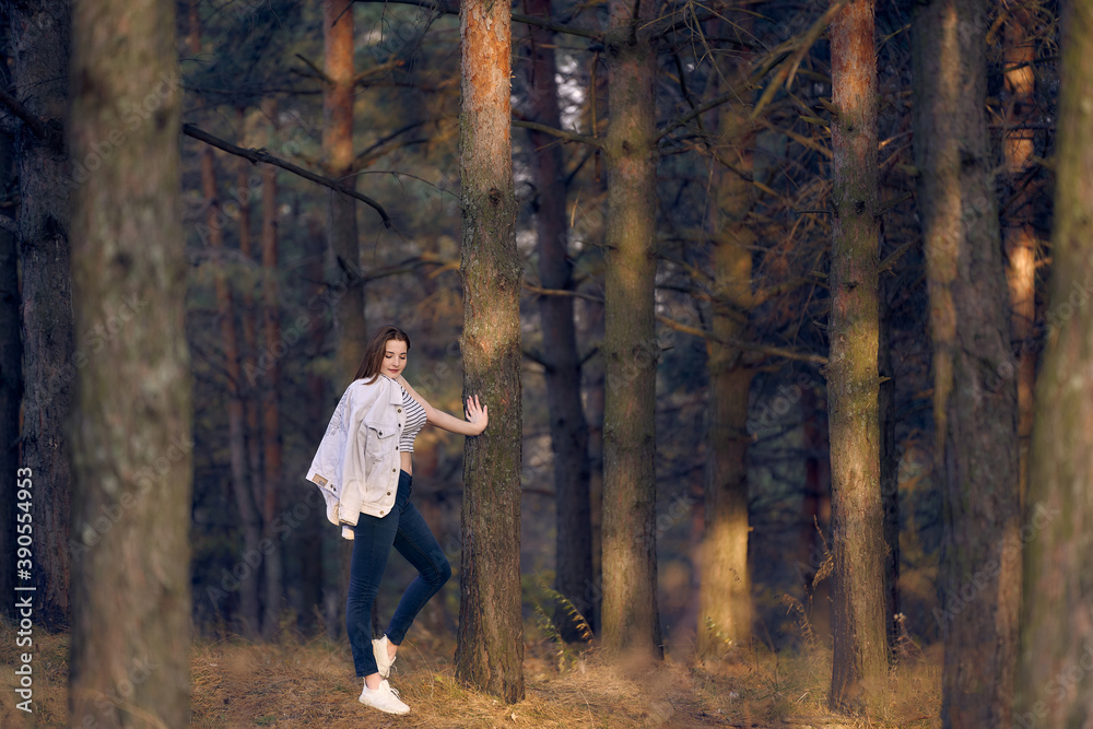 Woman in jeans and a white jacket in nature. beauty of autumn nature. Woman in jeans and a white jacket in nature. beauty of autumn nature.