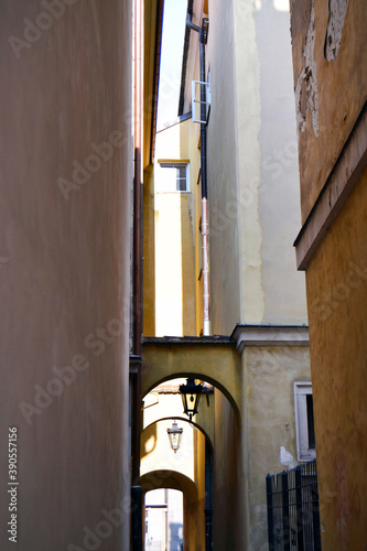Narrow street with arch way and old lanterns  Old Town  Stare Miasto   Warsaw  Poland