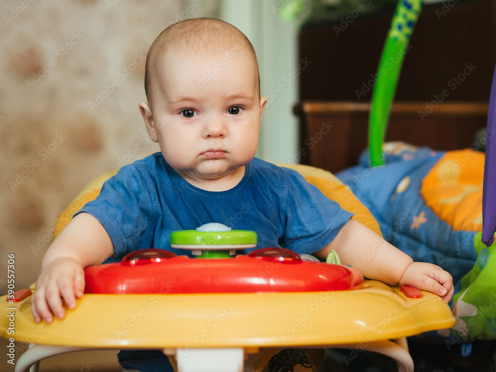 portrait of a cute Caucasian baby boy in a Walker portrait of a cute Caucasian baby boy in a Walker