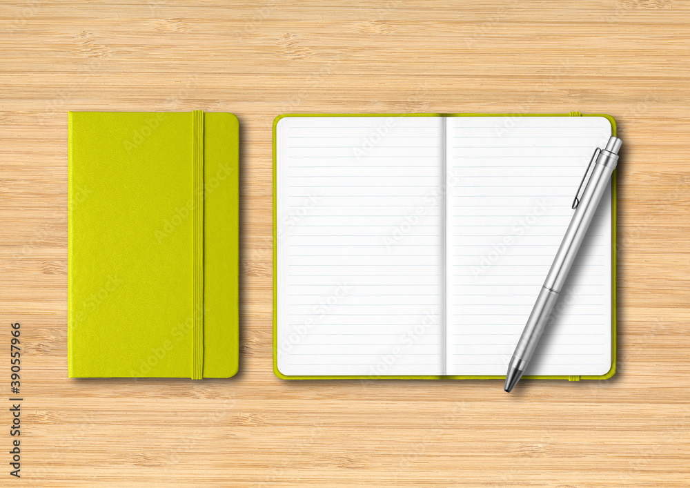 Lime green closed and open lined notebooks with a pen on wooden background Lime green closed and open lined notebooks with a pen on wooden background