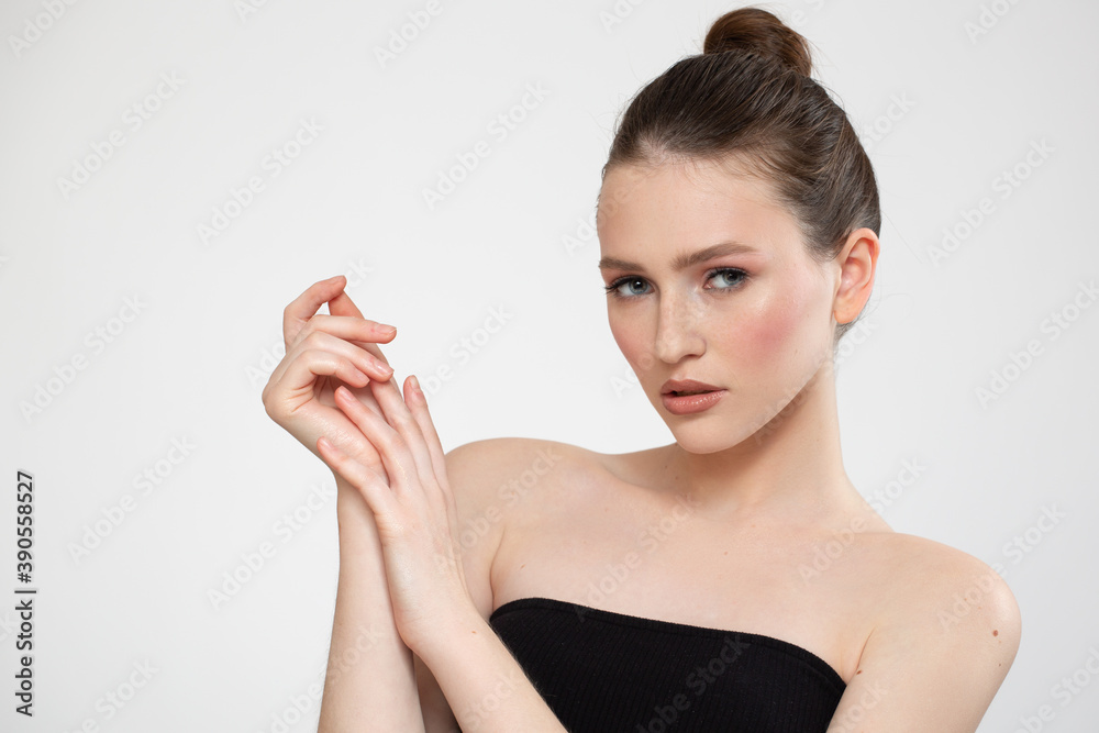 Portrait of a beautiful young woman with clean skin of face and body on a white background. spa care concept. Copycpase Portrait of a beautiful young woman with clean skin of face and body on a white background. spa care concept. Copycpase