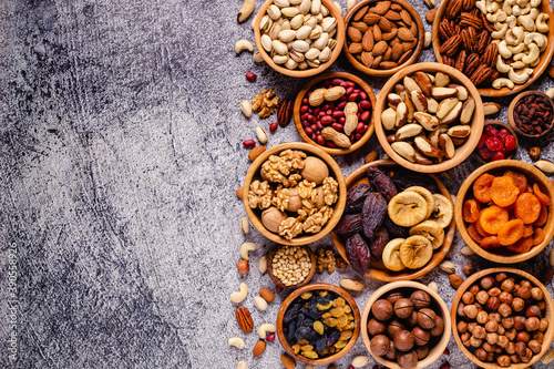 Various Nuts and dried fruits in wooden bowls.