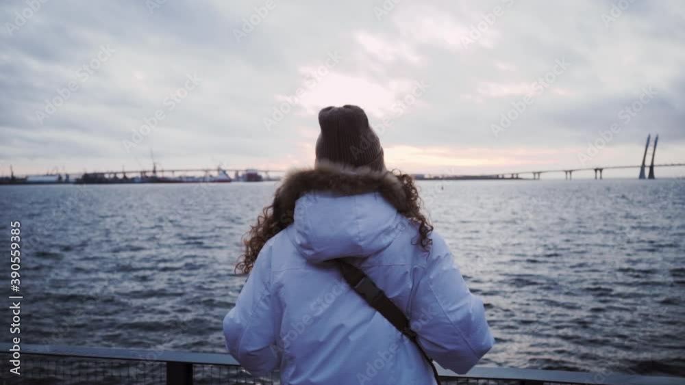 Norwegian Cloudy Sea. The girl is enjoying the view. Scandinavian Foggy seascape. Cloudy dramatic landscape. Blue time Norwegian Cloudy Sea. The girl is enjoying the view. Scandinavian Foggy seascape. Cloudy dramatic landscape. Blue time