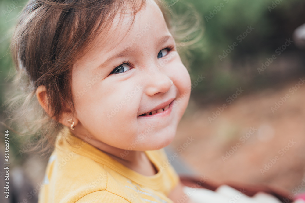 Portrait of a cute Little girl with blue eyes in nature in the forest Portrait of a cute Little girl with blue eyes in nature in the forest