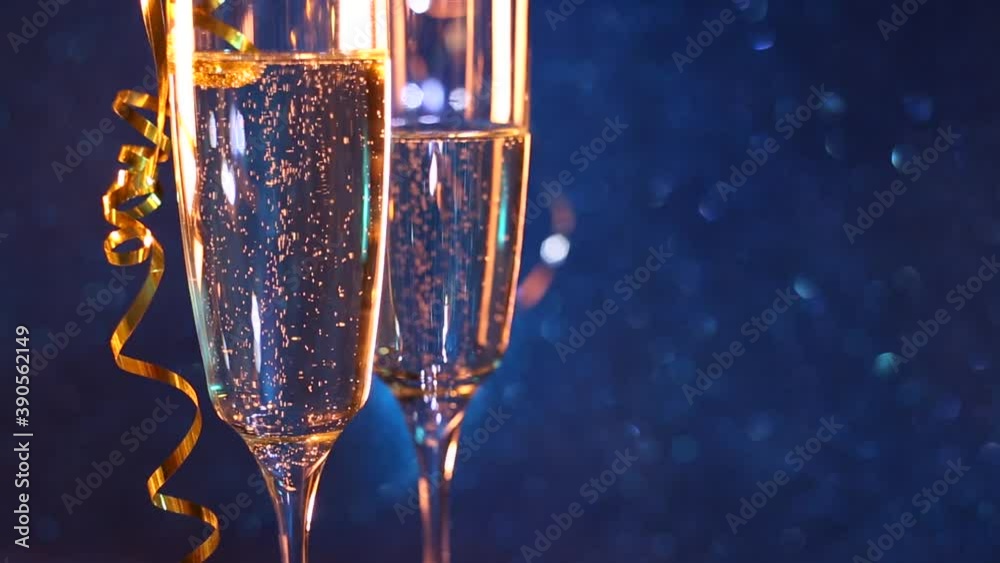 Christmas and New Year holiday background with two goblet,wine glass champagne and blue bokeh effect background. Happy New Year!