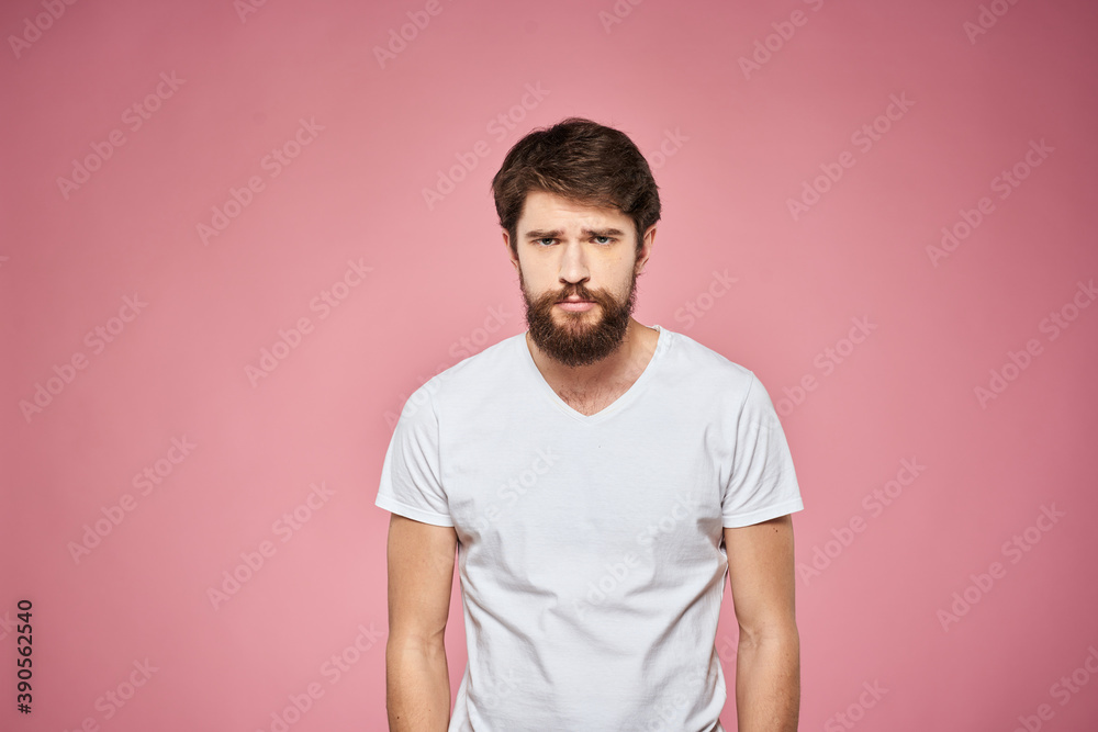 Man in white t-shirt emotions lifestyle facial expression cropped view pink background.