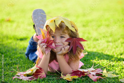 Autumn Face of cute Kid in fall yellow leaves  little Child in park outdoor  clothing for october Season.