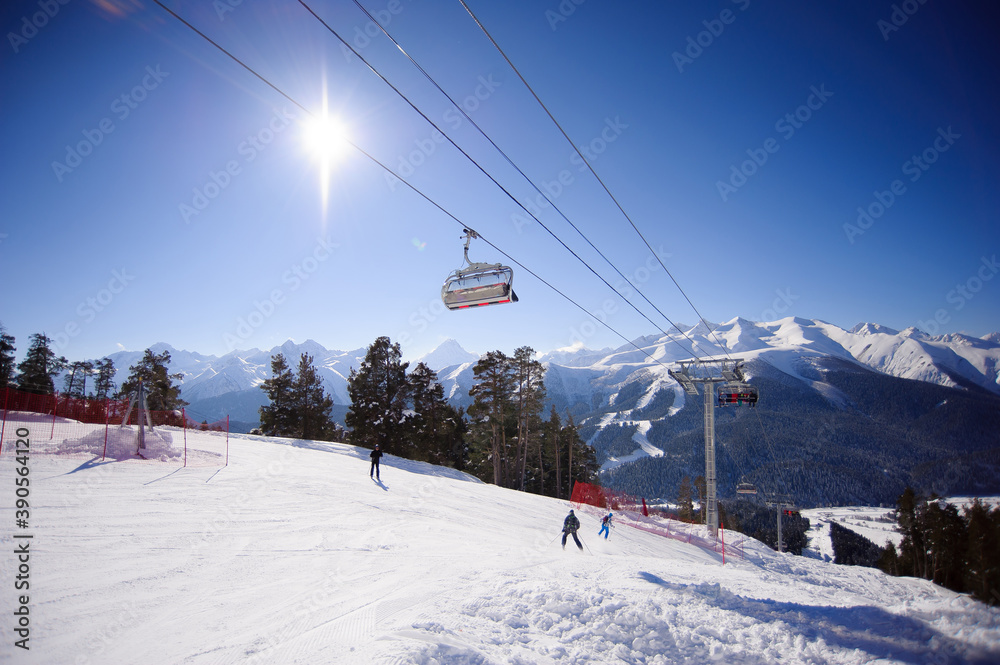 Ski lift with seats going over the mountain and paths from skies and snowboards. Ski lift with seats going over the mountain and paths from skies and snowboards.