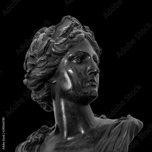 White marble sculpture head of young woman. Statue of sensual renaissance art era naked woman in circlet antique style isolated on black background
