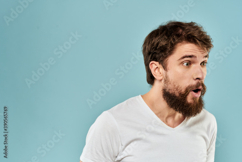 Bearded man emotions facial expression gestures hands close-up blue background