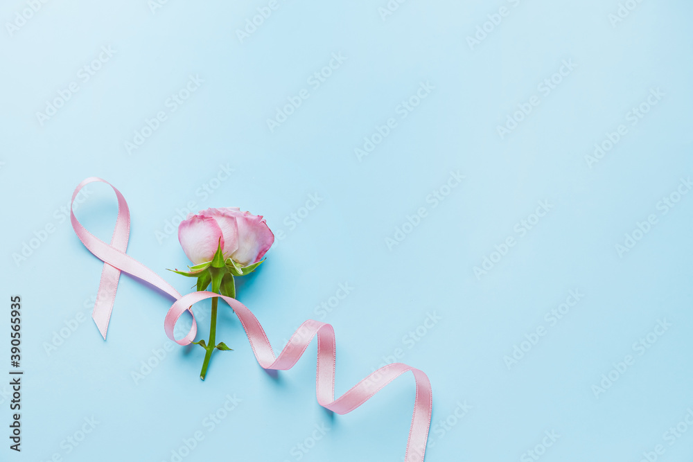 Pink ribbon and rose on color background. Breast cancer awareness concept Pink ribbon and rose on color background. Breast cancer awareness concept