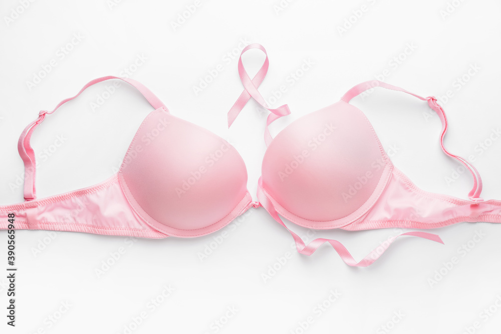 Pink ribbon and bra on white background. Breast cancer awareness concept Pink ribbon and bra on white background. Breast cancer awareness concept