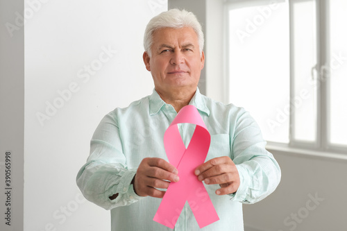 Mature man with pink ribbon...