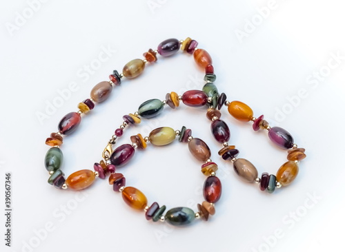 Purchased beads of colored stones close-up on a white background