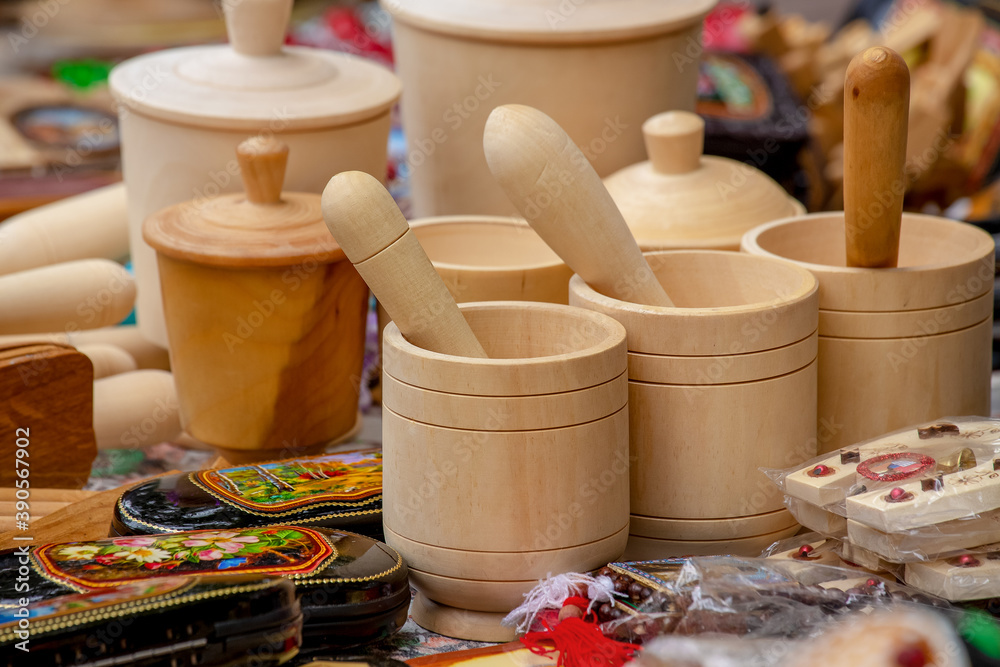 A variety of wooden crafts for the kitchen. Mortar and pestle. Side view of a group of wooden mortar and pestle sold at a fair. A variety of wooden crafts for the kitchen. Mortar and pestle. Side view of a group of wooden mortar and pestle sold at a fair.