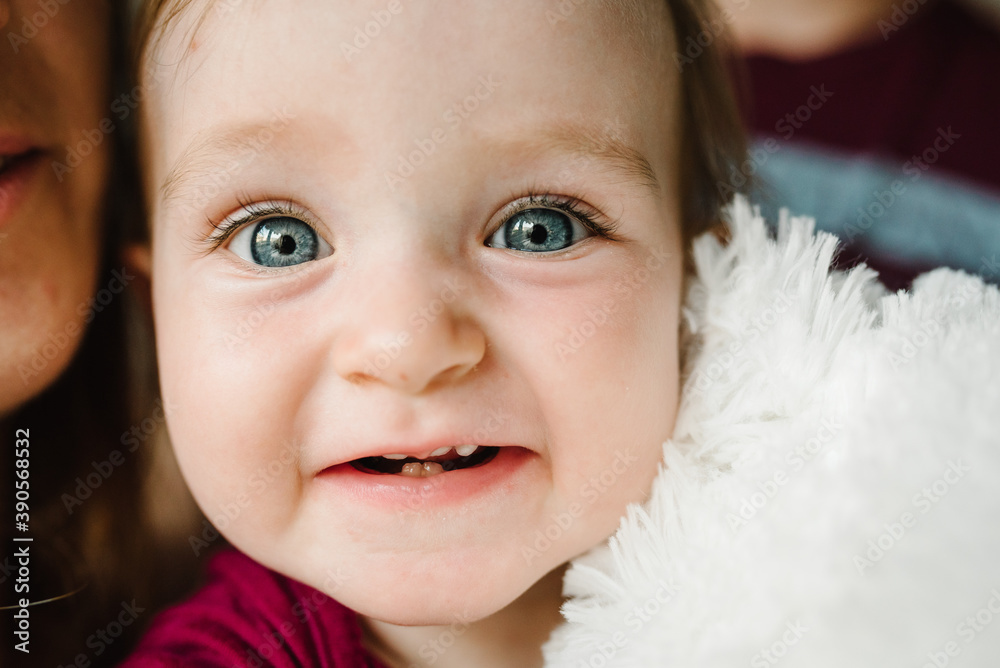 Baby. The father, mother holds little girl. Portrait of daughter. The concept of family holiday. Close up face. Baby. The father, mother holds little girl. Portrait of daughter. The concept of family holiday. Close up face.