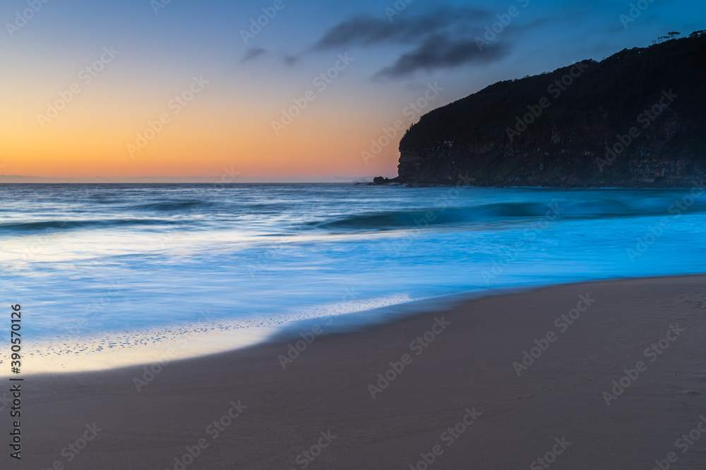 Hazy sunrise seascape with low swell