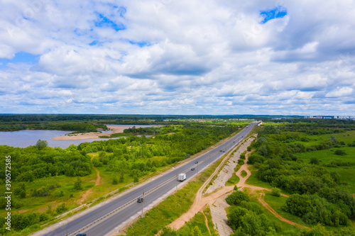 Panorama of the Kirov city and Oktyabrsky district in the nord part of the city of Kirov on a summer day from above. highway across the bridge over the Vyatka river at the entrance to the city.