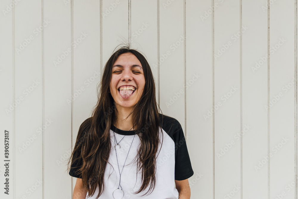 Young beautiful woman outdoors, casual clothes, happy smile, in front of white wooden planks wall, copy space, feminine concept, woman campaign, relax, social media Young beautiful woman outdoors, casual clothes, happy smile, in front of white wooden planks wall, copy space, feminine concept, woman campaign, relax, social media