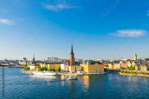 Watercolor drawing of Aerial panoramic top view of Riddarholmen district with Riddarholm Church and typical sweden gothic buildings, boat ship sailing on water of Lake Malaren in Stockholm, Sweden © Aliaksandr