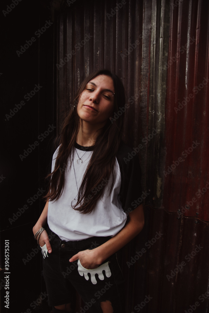 Young beautiful woman outdoors, casual clothes, happy smile, wall of red plates, rustic, copy space, feminine concept, woman campaign, entertainment, social media Young beautiful woman outdoors, casual clothes, happy smile, wall of red plates, rustic, copy space, feminine concept, woman campaign, entertainment, social media