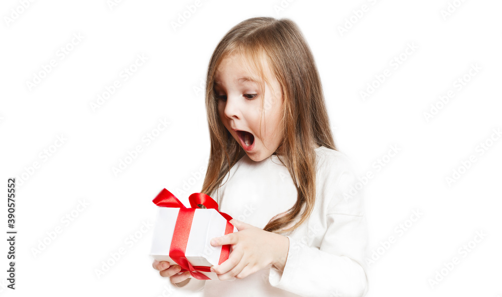 Happy laughing little girl, adorable preschooler holding birthday present, gift box with red bow. excited and surprised. on white background.