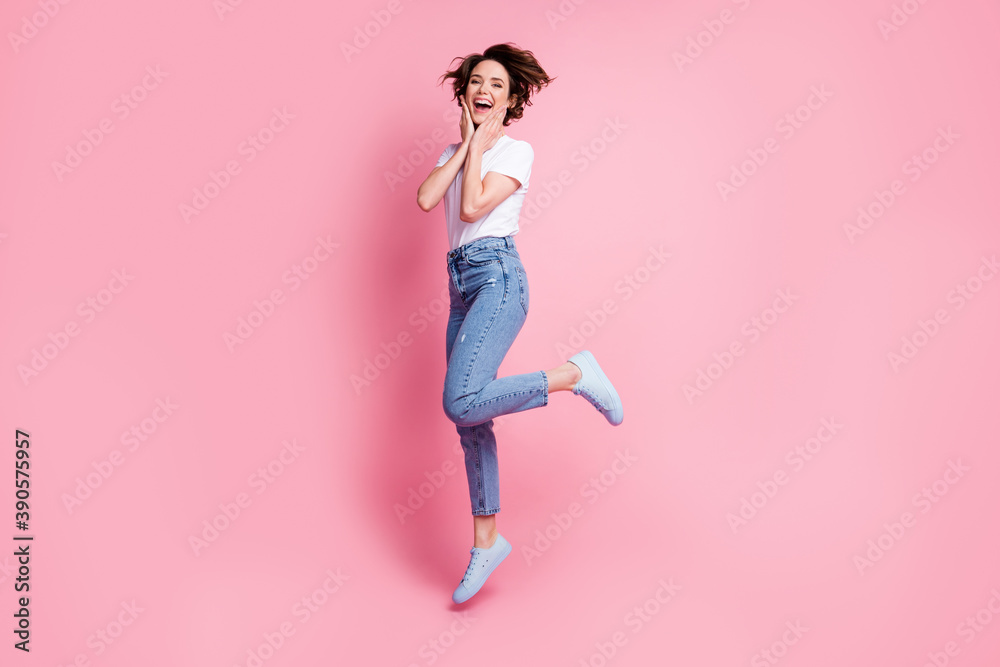 Full length body size profile side view of nice glad cheerful brown-haired girl jumping having fun isolated over pink pastel color background Full length body size profile side view of nice glad cheerful brown-haired girl jumping having fun isolated over pink pastel color background