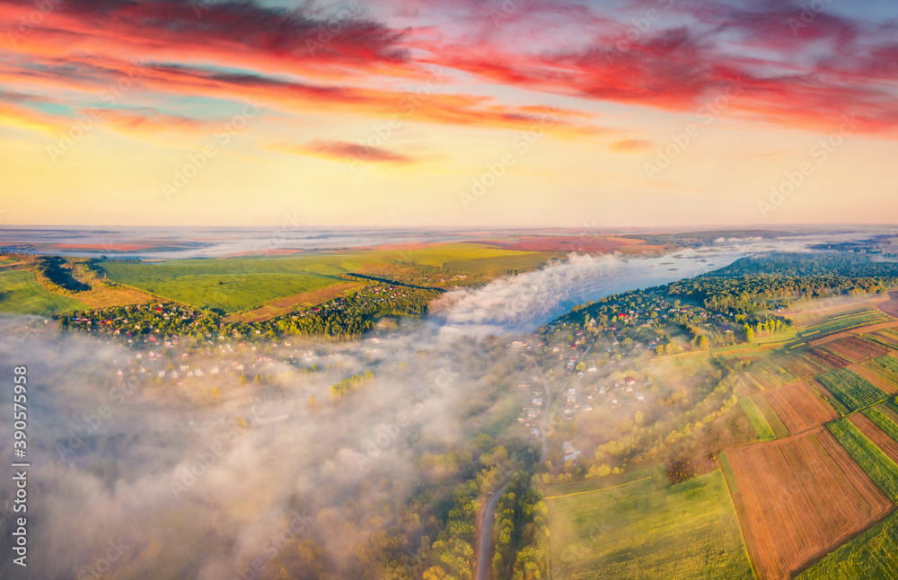 Fantastic summer sunrise on Ivachiv lake, Ternopil region. Colorful rural scene from flying drone of Ukrainian countryside. Traveling concept background.