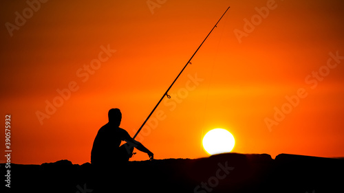 silhouette of a fisherman