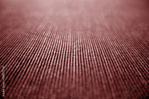 Textile pattern close-up with blur defocused effect in red color.