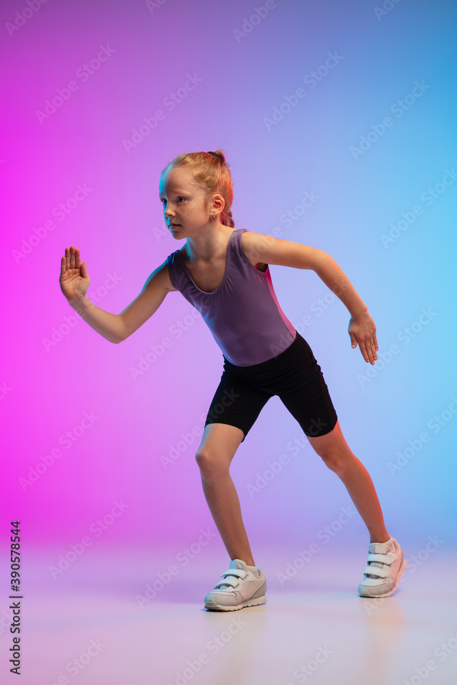 Ready. Teenage girl, professional runner, jogger in action, motion isolated on gradient pink-blue background in neon light. Concept of sport, movement, energy and dynamic, healthy lifestyle. Ready. Teenage girl, professional runner, jogger in action, motion isolated on gradient pink-blue background in neon light. Concept of sport, movement, energy and dynamic, healthy lifestyle.