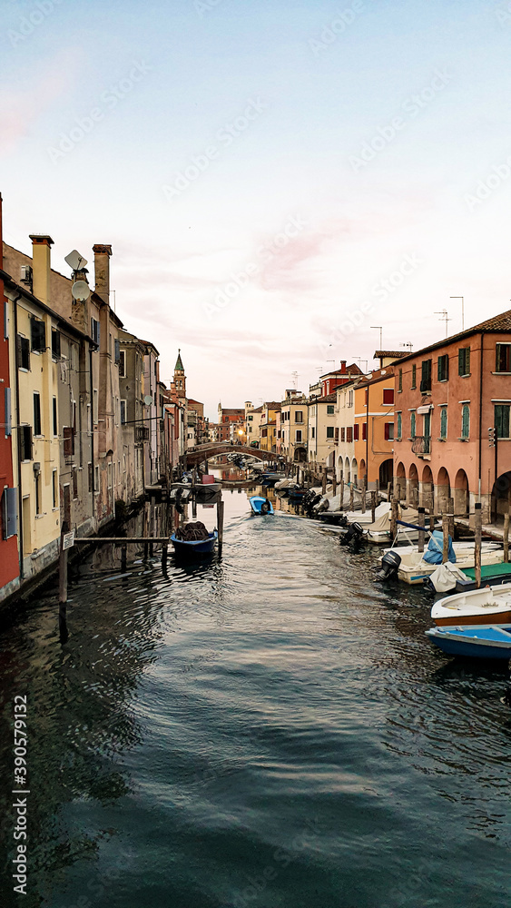 Chioggia town in venetian lagoon, water canal and church. Veneto, Italy.